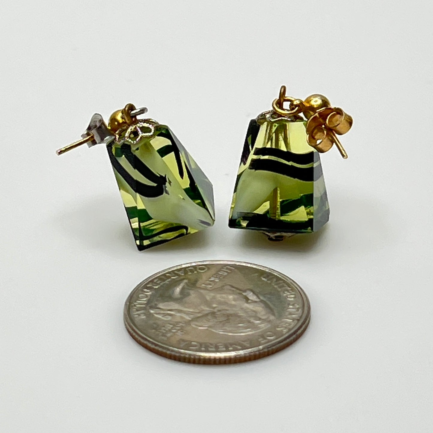 Green glass pyramid earrings with black swirl pattern, vintage 1980s pierced dangle design