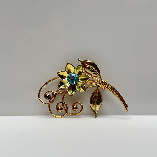 Vintage gold-filled floral brooch with blue rhinestone, signed Harry Iskin