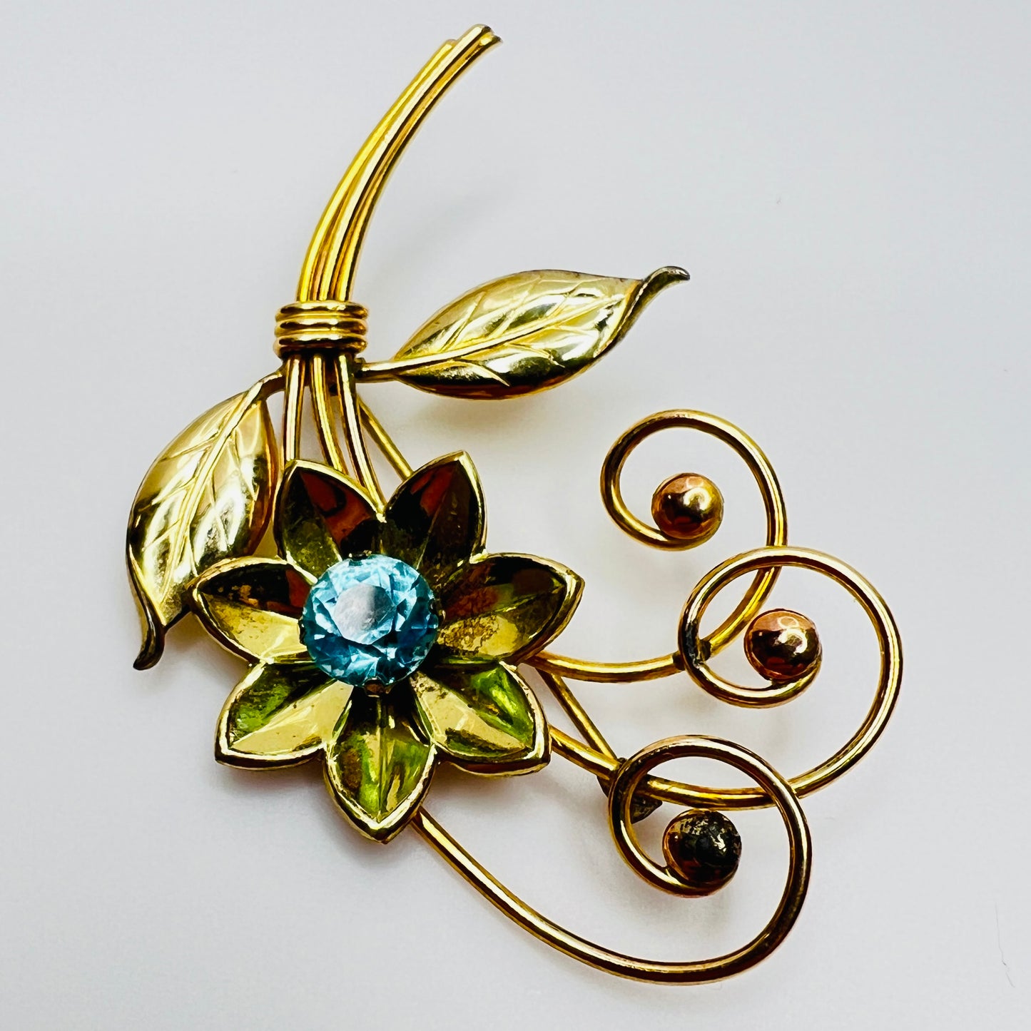 Vintage gold-filled floral brooch with blue rhinestone, signed Harry Iskin
