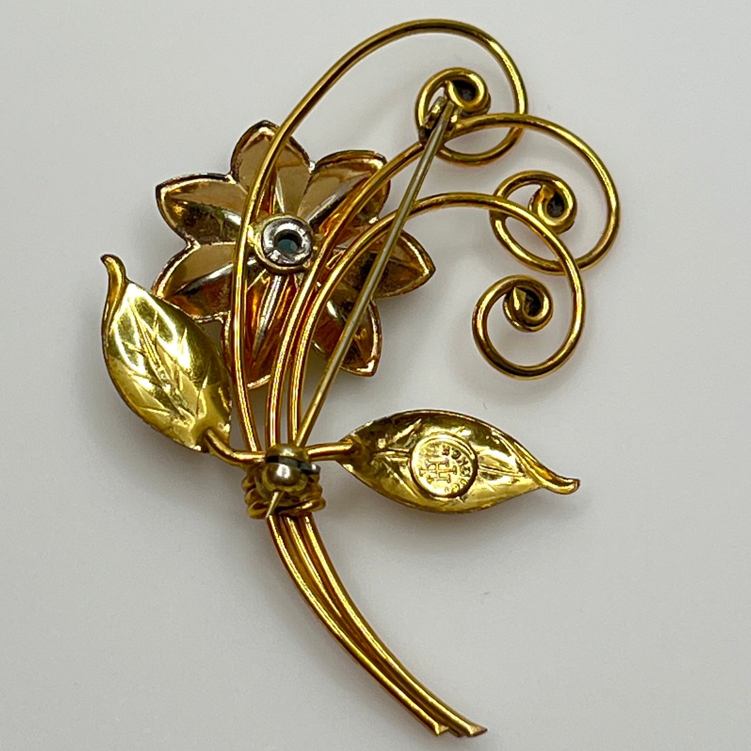 Vintage gold-filled floral brooch with blue rhinestone, signed Harry Iskin