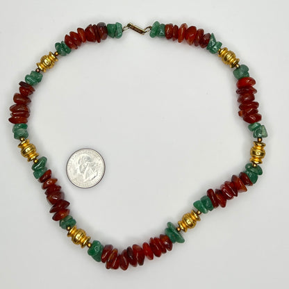 Necklace laid flat with U.S. quarter for scale, showing stone chips and gold spacers