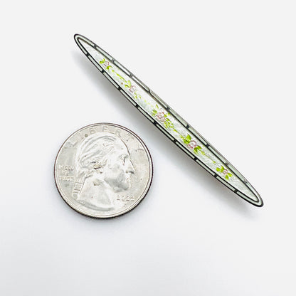 Edwardian floral enamel sterling bar brooch beside quarter for scale