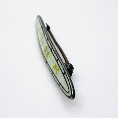 Side view of antique sterling silver enamel brooch showing C-clasp pin
