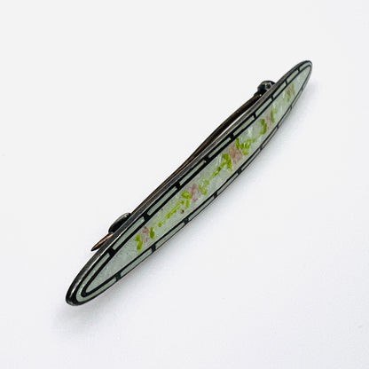 Side view of antique sterling silver enamel brooch showing C-clasp pin