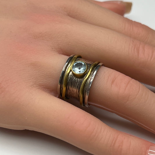 Wide sterling silver and brass spinner ring with blue sapphire stone, size 7