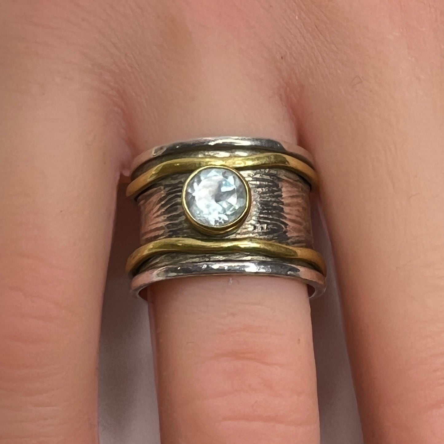 Wide sterling silver and brass spinner ring with blue sapphire stone, size 7