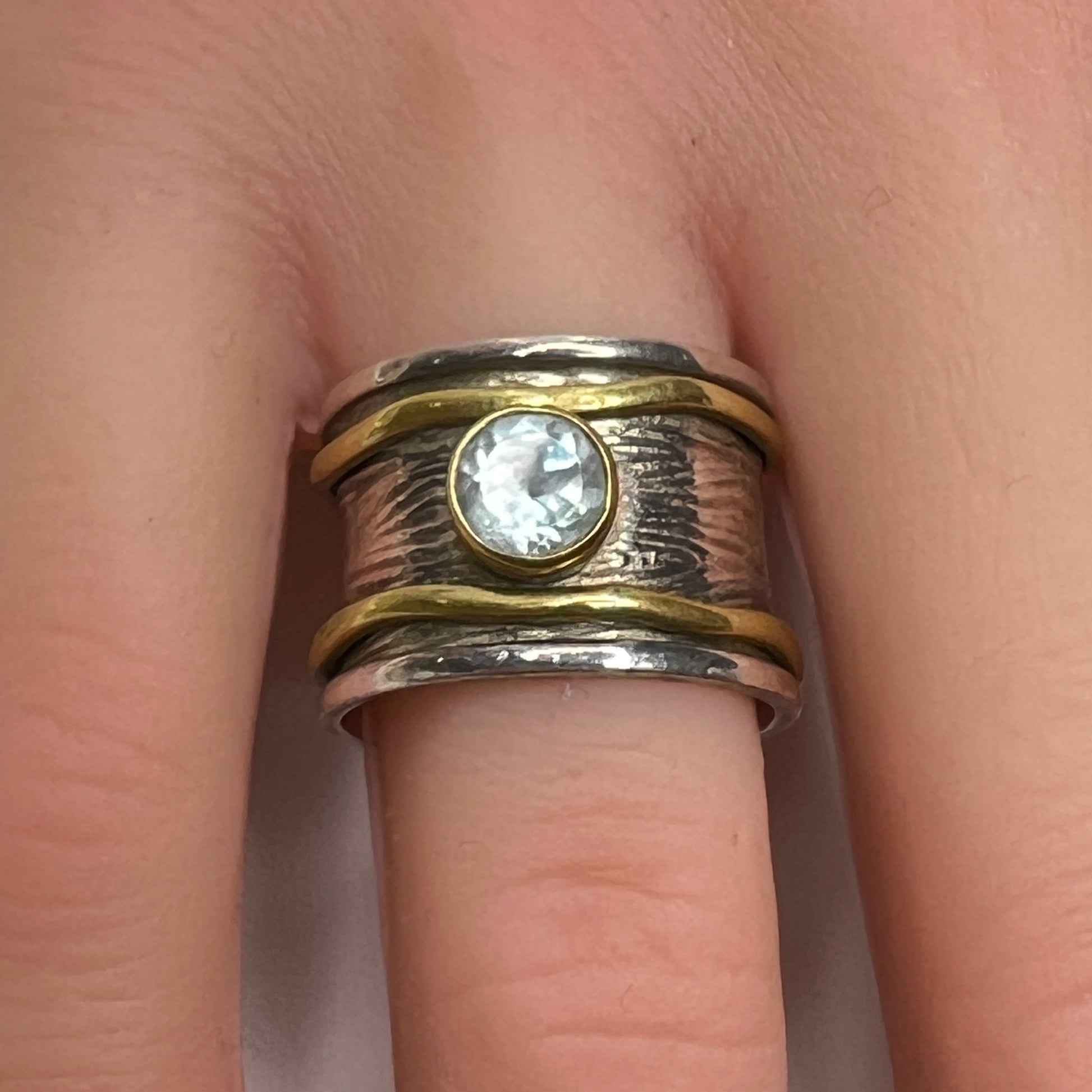 Wide sterling silver and brass spinner ring with blue sapphire stone, size 7