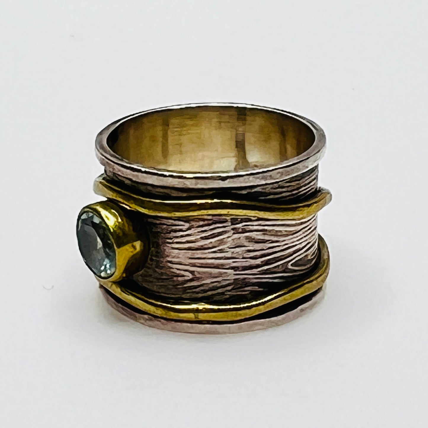 Wide sterling silver and brass spinner ring with blue sapphire stone, size 7