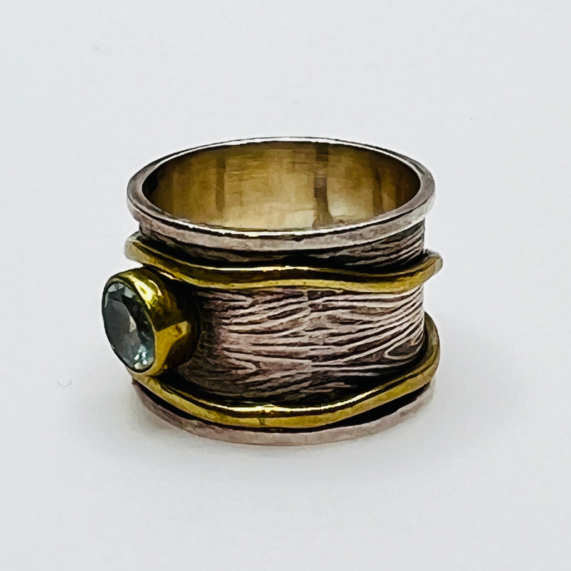 Wide sterling silver and brass spinner ring with blue sapphire stone, size 7