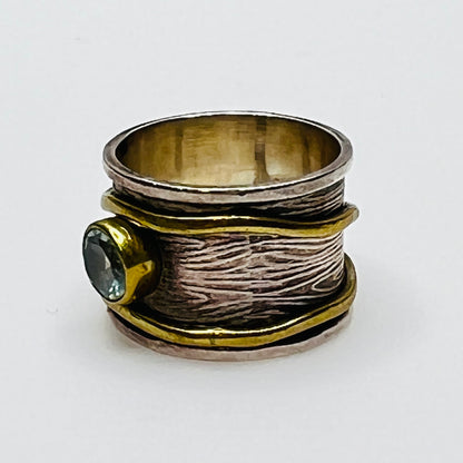 Wide sterling silver and brass spinner ring with blue sapphire stone, size 7