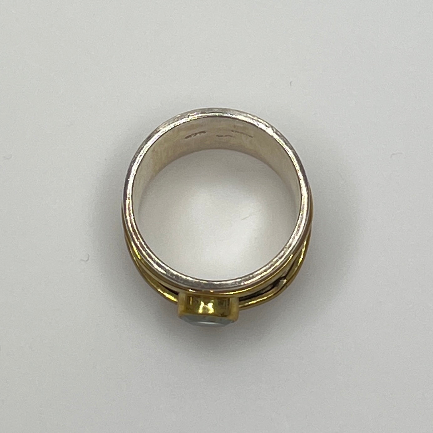 Close-up of vintage fidget worry ring with sapphire and mixed metals