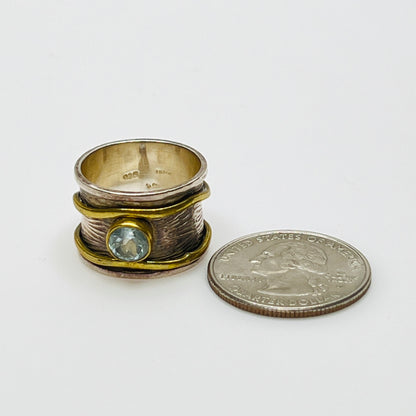 Close-up of vintage fidget worry ring with sapphire and mixed metals