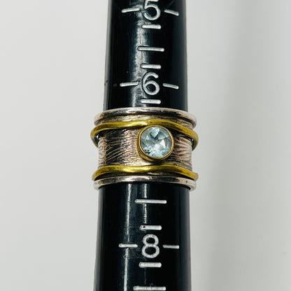 Close-up of vintage fidget worry ring with sapphire and mixed metals