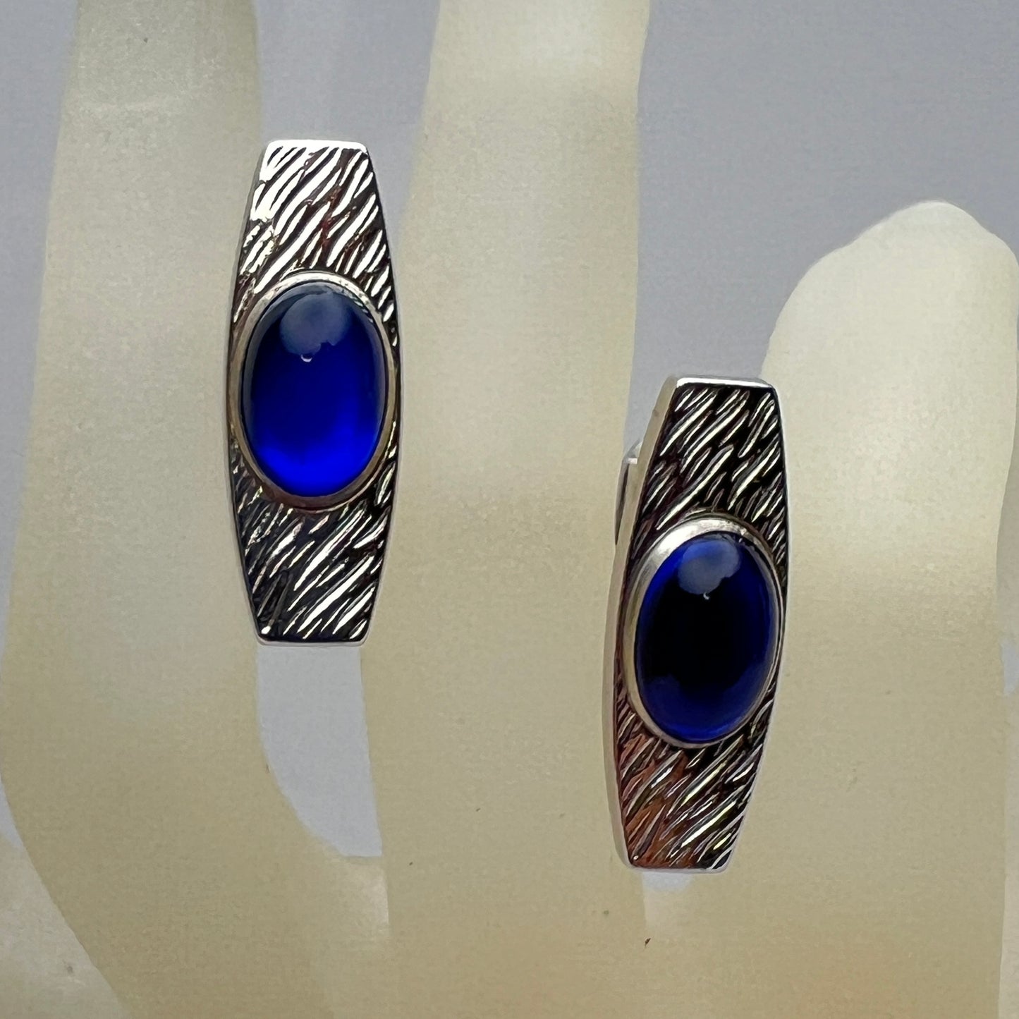 Silver-tone cufflinks with textured finish and vivid blue lucite cabochons, signed Anson