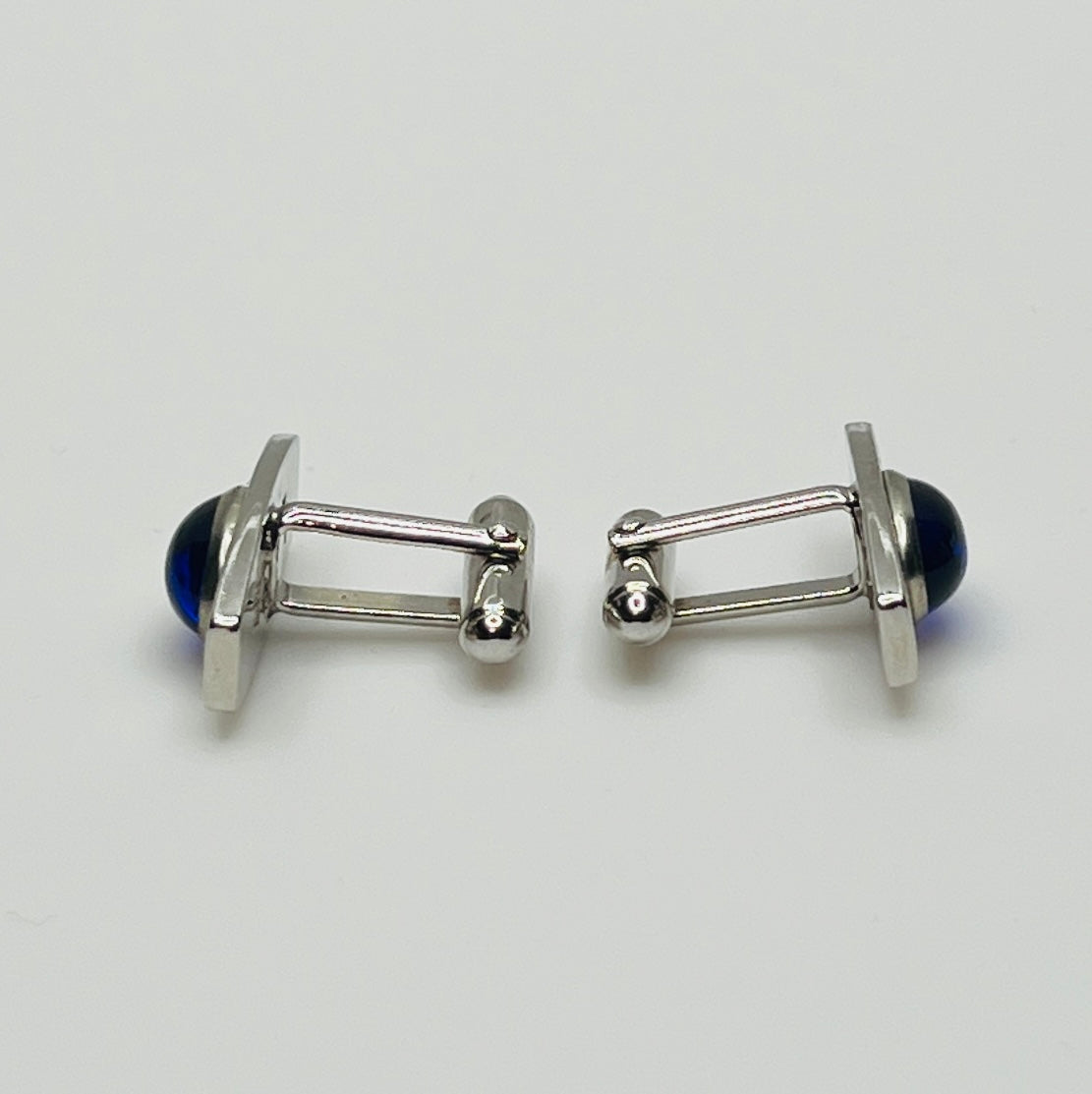 Silver-tone cufflinks with textured finish and vivid blue lucite cabochons, signed Anson