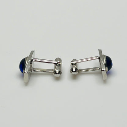 Silver-tone cufflinks with textured finish and vivid blue lucite cabochons, signed Anson