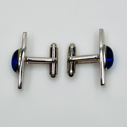 Silver-tone cufflinks with textured finish and vivid blue lucite cabochons, signed Anson