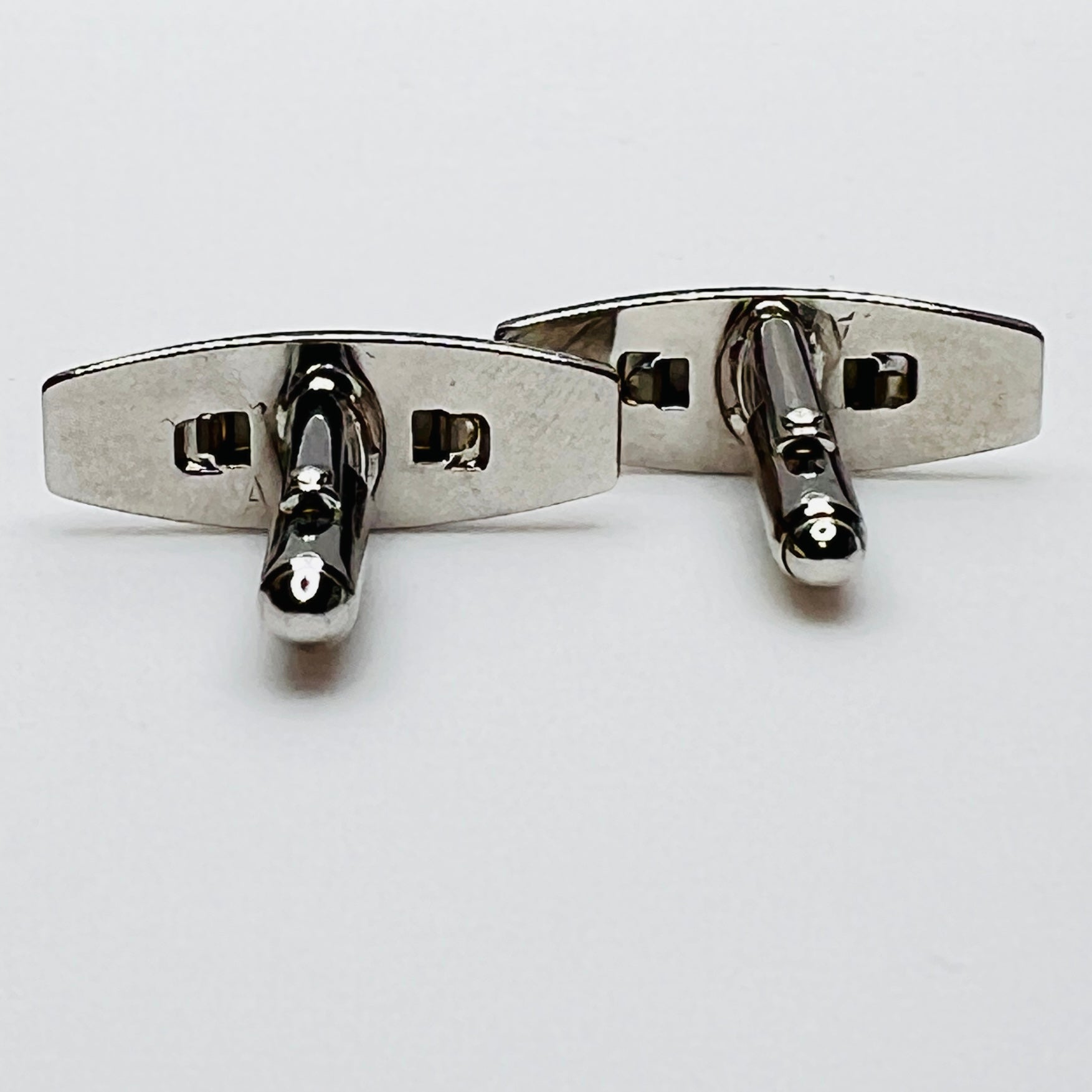 Silver-tone cufflinks with textured finish and vivid blue lucite cabochons, signed Anson