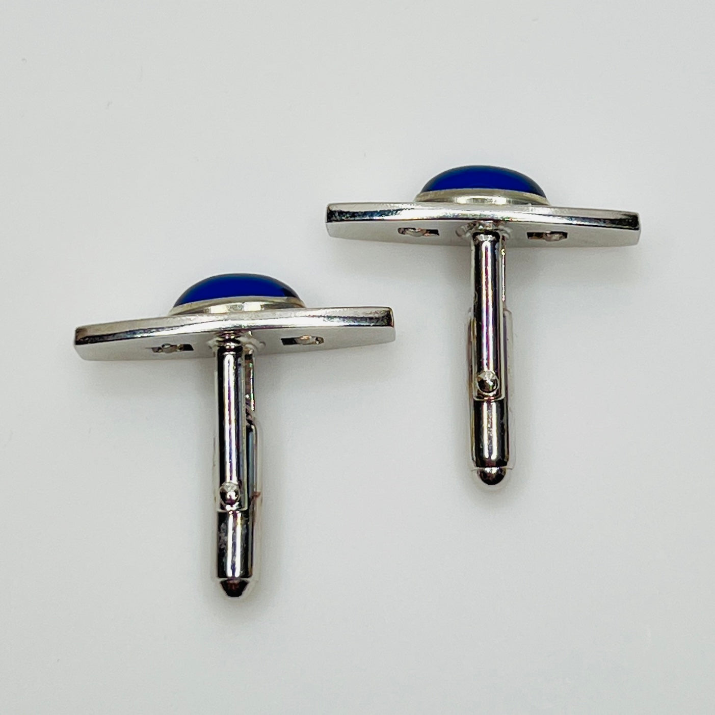 Silver-tone cufflinks with textured finish and vivid blue lucite cabochons, signed Anson