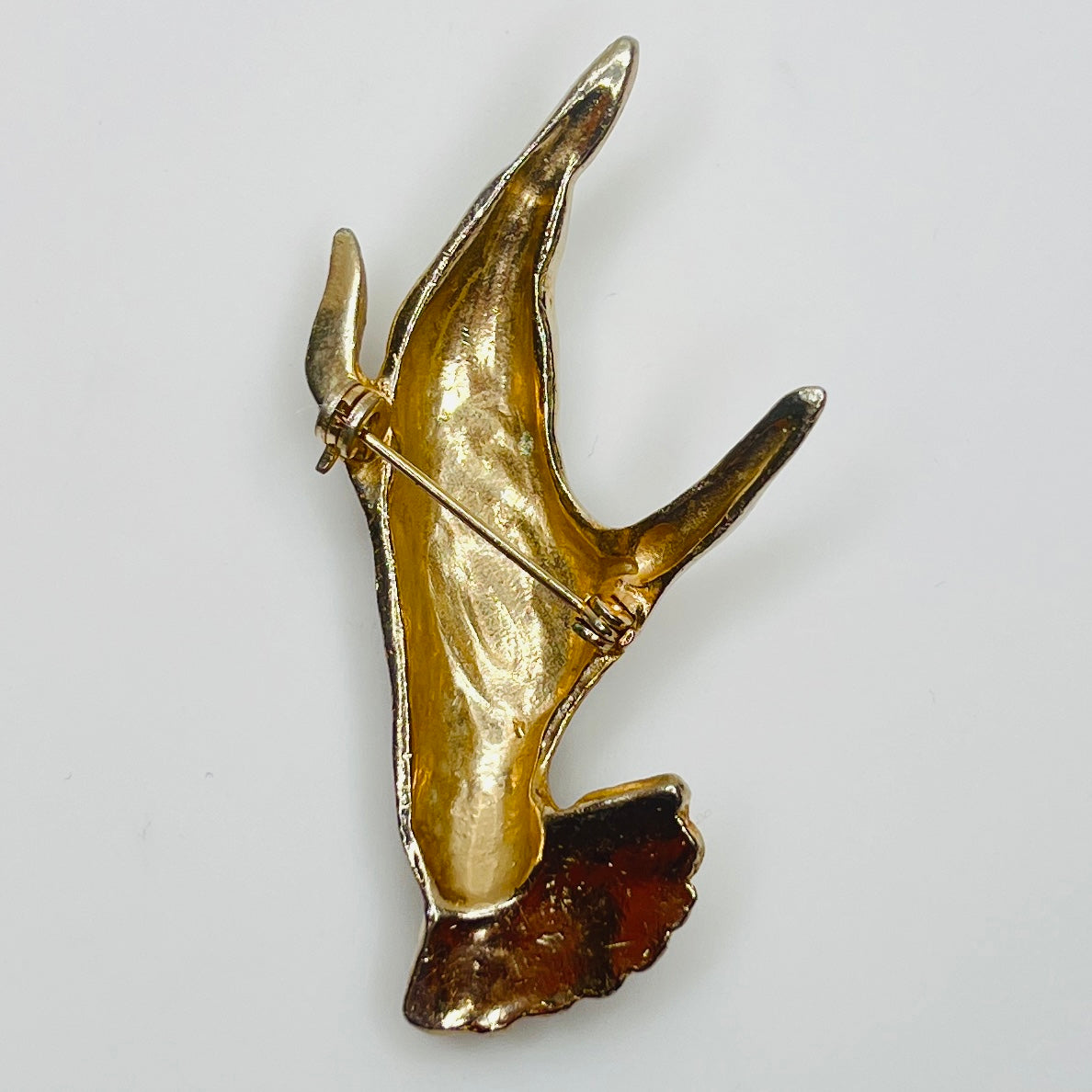 Back of unsigned 1950s silver tone hand pin