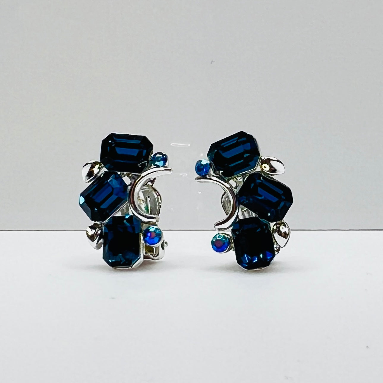 Lisner clip-on earrings with sapphire blue rhinestones and silver-tone setting