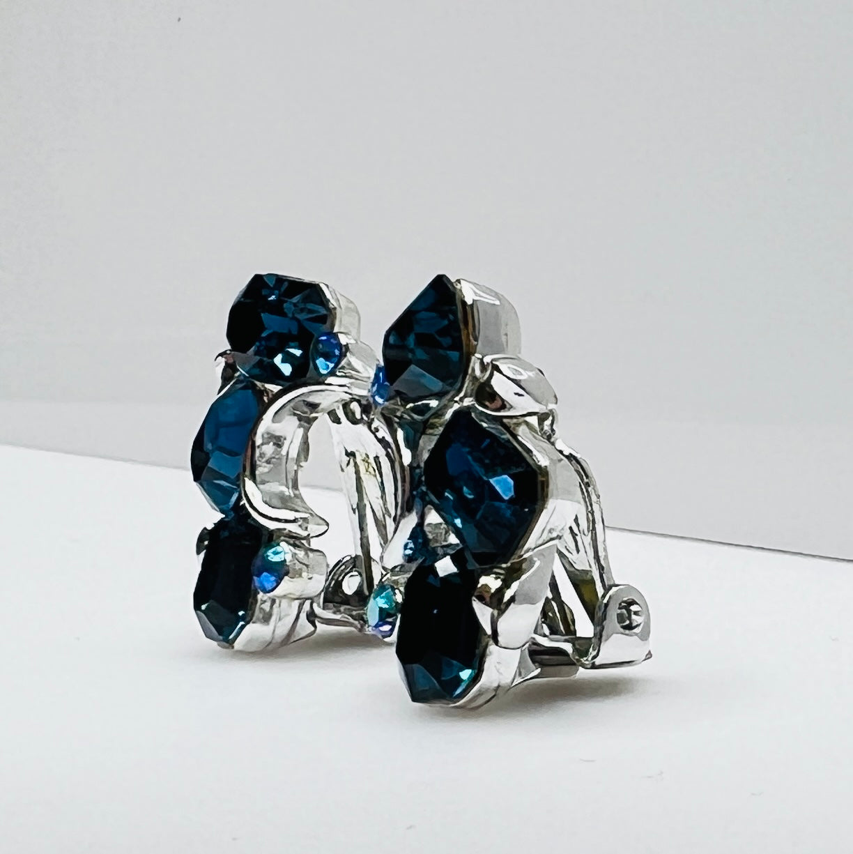 Lisner clip-on earrings with sapphire blue rhinestones and silver-tone setting