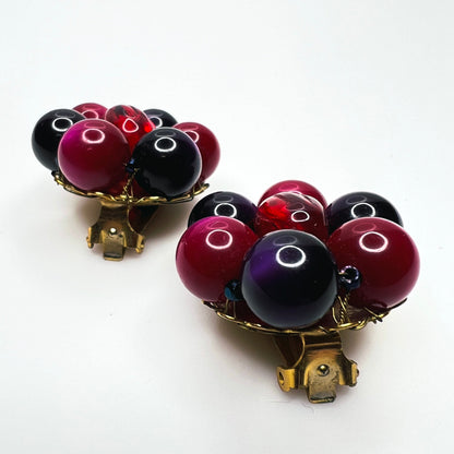 Side view of vintage Marvella dimensional bead cluster clip earrings with gold-tone metal settings.