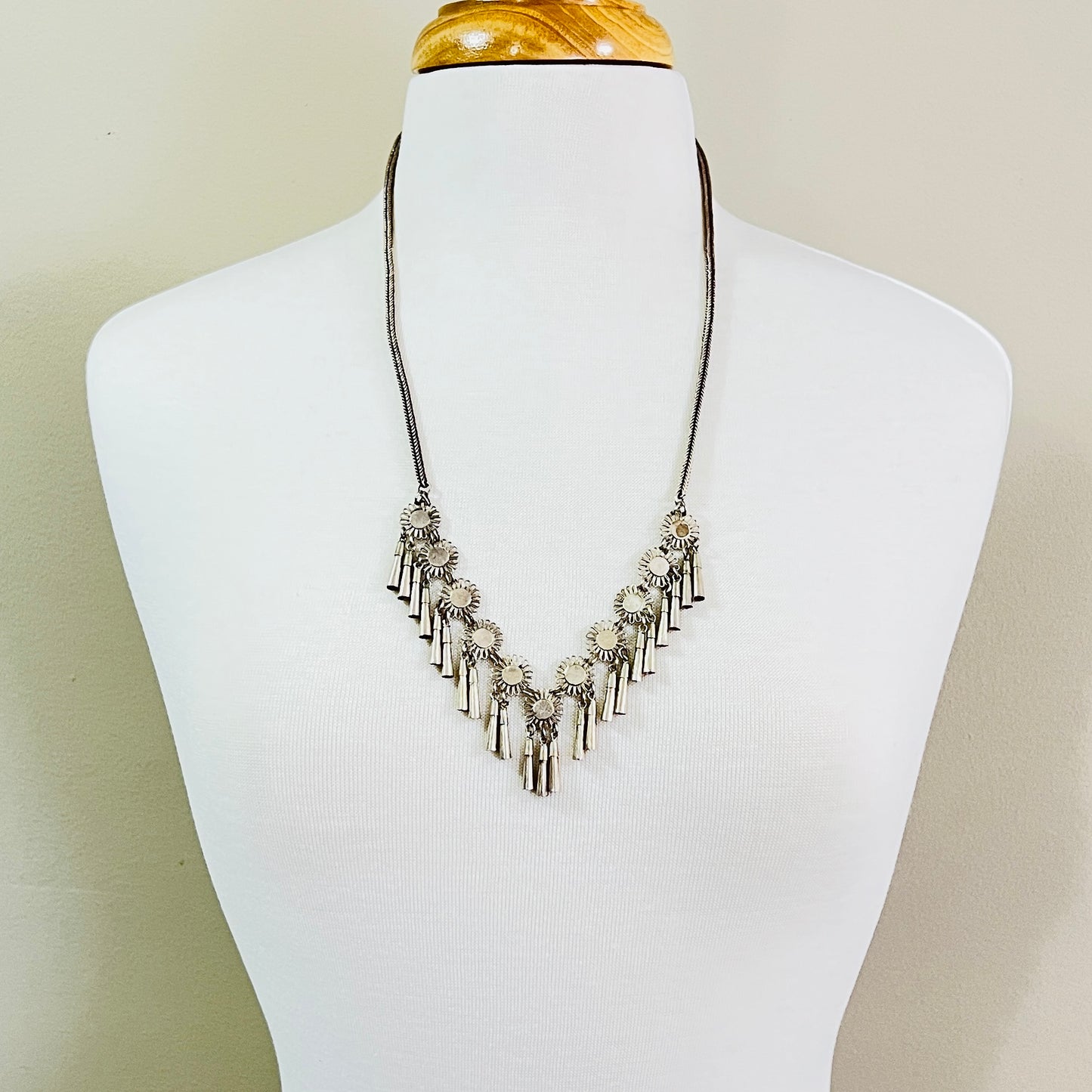 Vintage Miao Hmong silver tribal tassel necklace on display