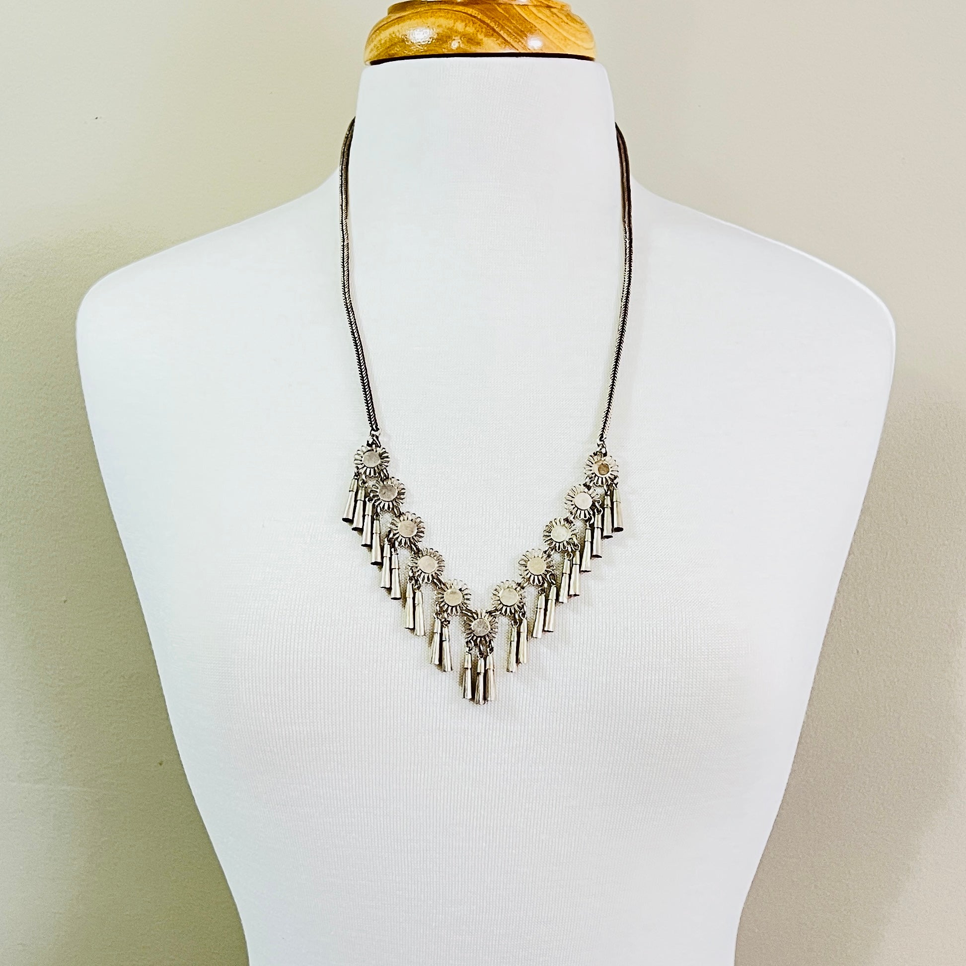 Vintage Miao Hmong silver tribal tassel necklace on display