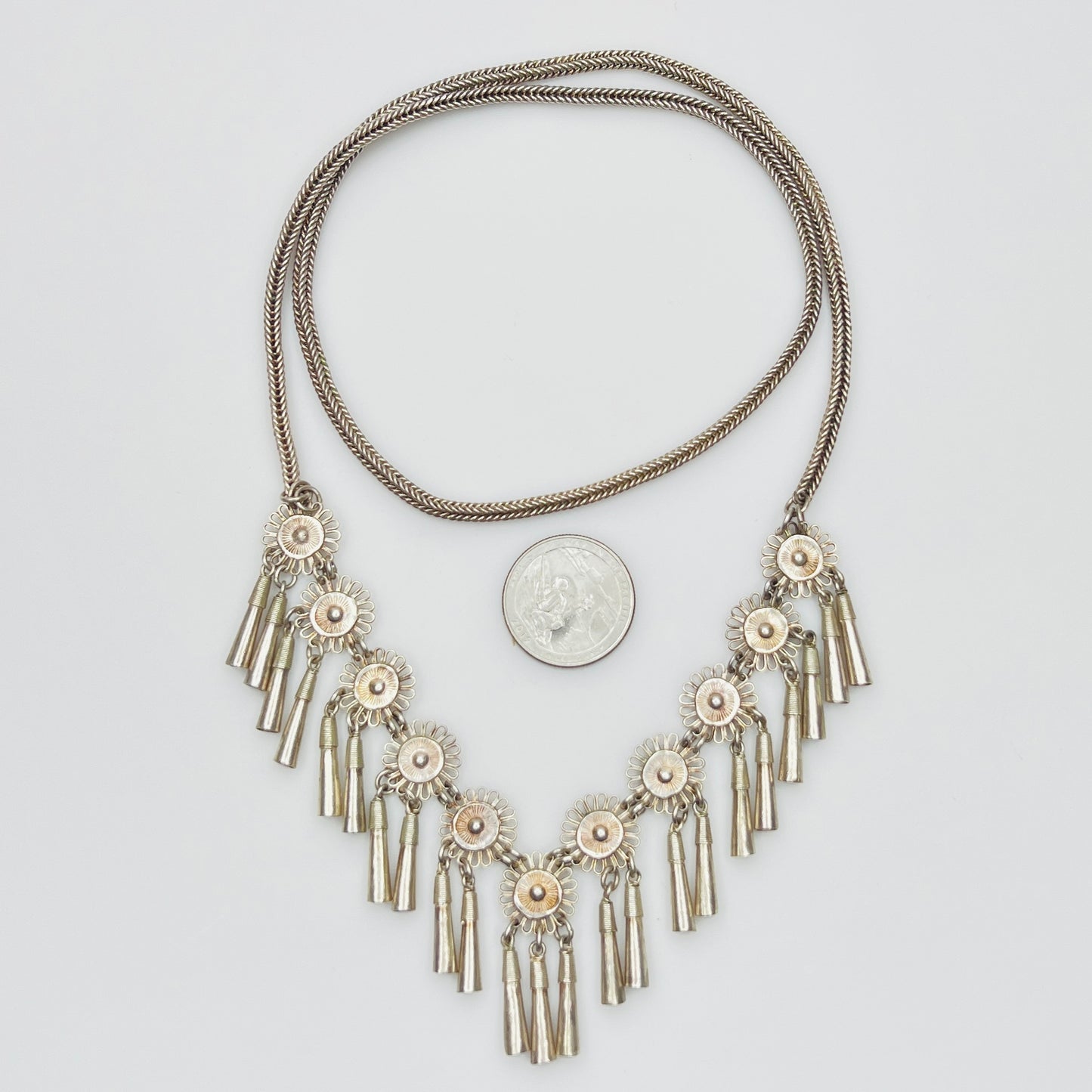 Vintage Miao Hmong silver tribal tassel necklace on display