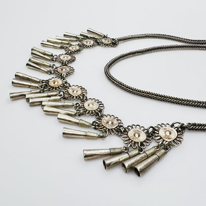 Side view of tribal flower fringe necklace with patina