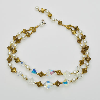 Double-strand necklace with faux pearls, iridescent crystals, and brass beads laid flat