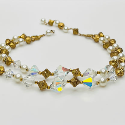 Double-strand necklace with faux pearls, iridescent crystals, and brass beads laid flat