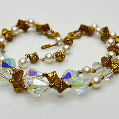 Double-strand necklace with faux pearls, iridescent crystals, and brass beads laid flat