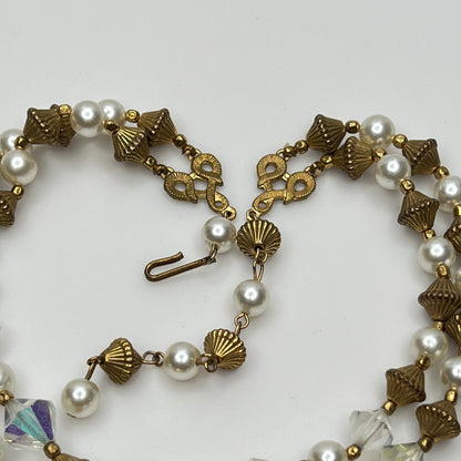 Double-strand necklace with faux pearls, iridescent crystals, and brass beads laid flat
