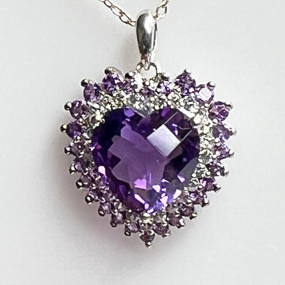 Close up cushion cut amethyst heart with diamond halo