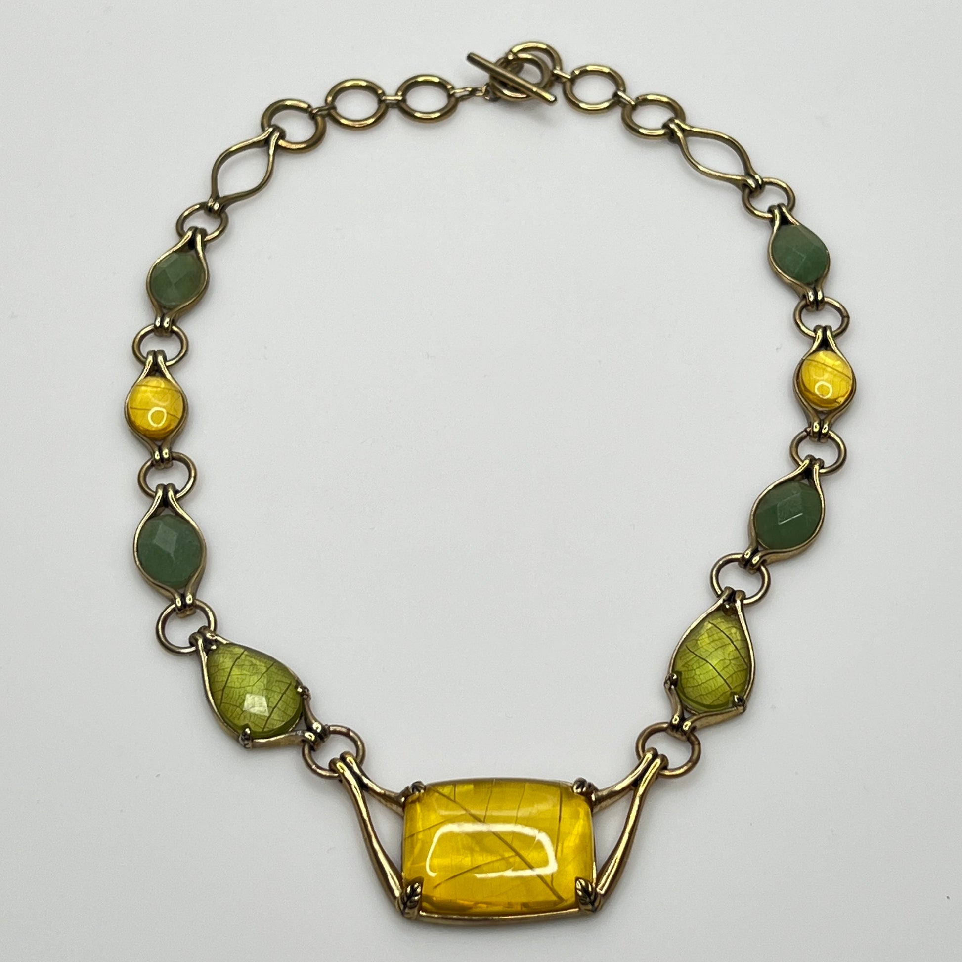 Vintage Monet necklace with green and yellow glass cabochons in gold-tone setting