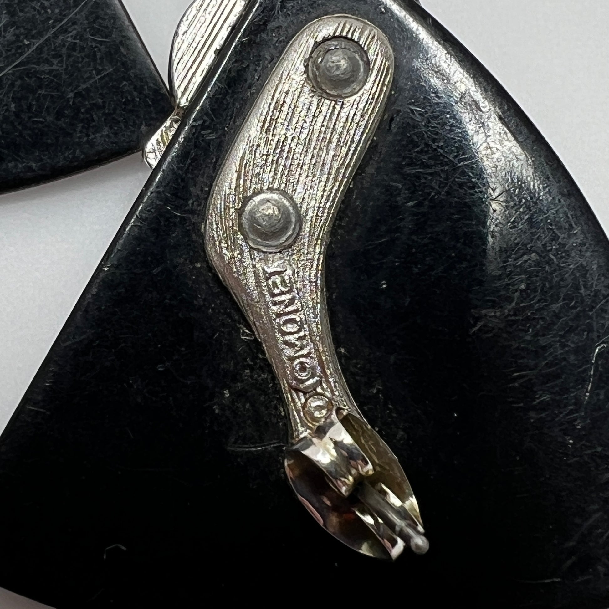 Close-up of signed Monet geometric earrings with Art Deco styling