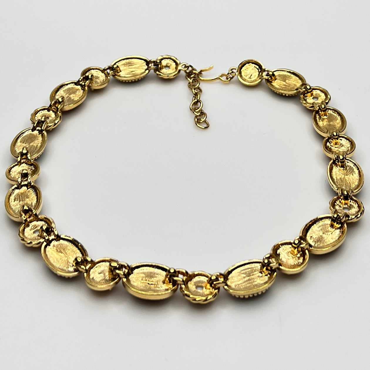 Overhead view of back of 1980s Monet necklace with adjustable clasp and oval stones