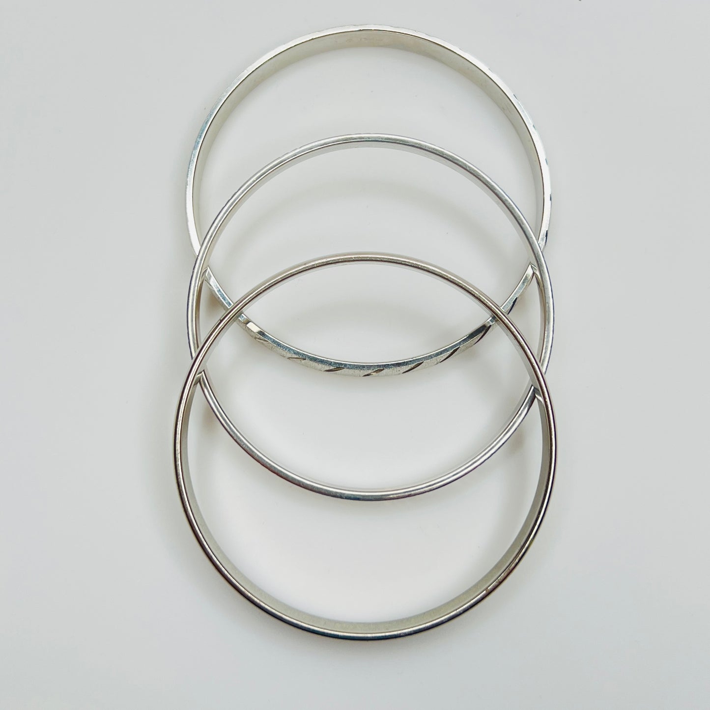 Monet silver tone bangle set with etched diagonal pattern