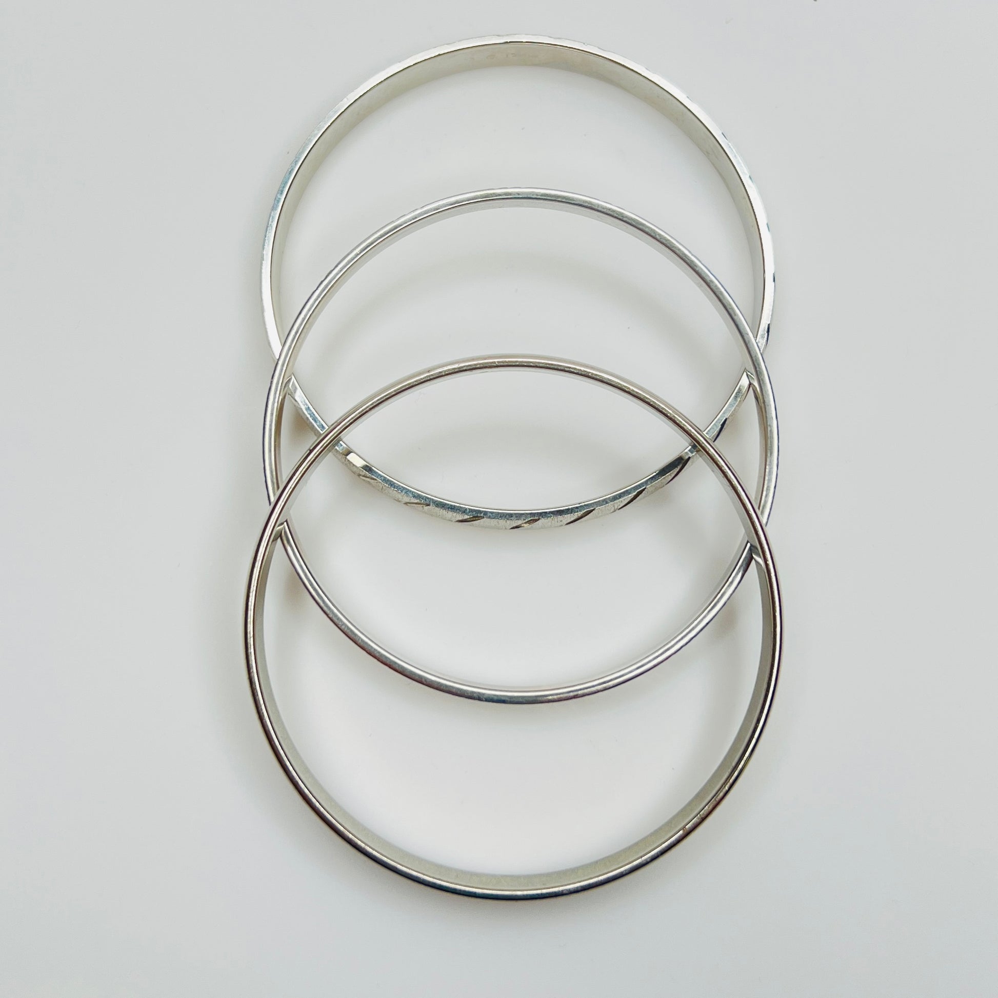 Monet silver tone bangle set with etched diagonal pattern
