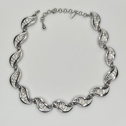 Overhead view of full silver Monet necklace with etched leaf design and extender chain