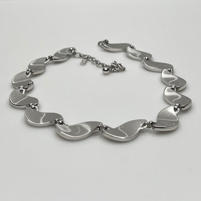side view Close-up of silver Monet choker with curved leaf links