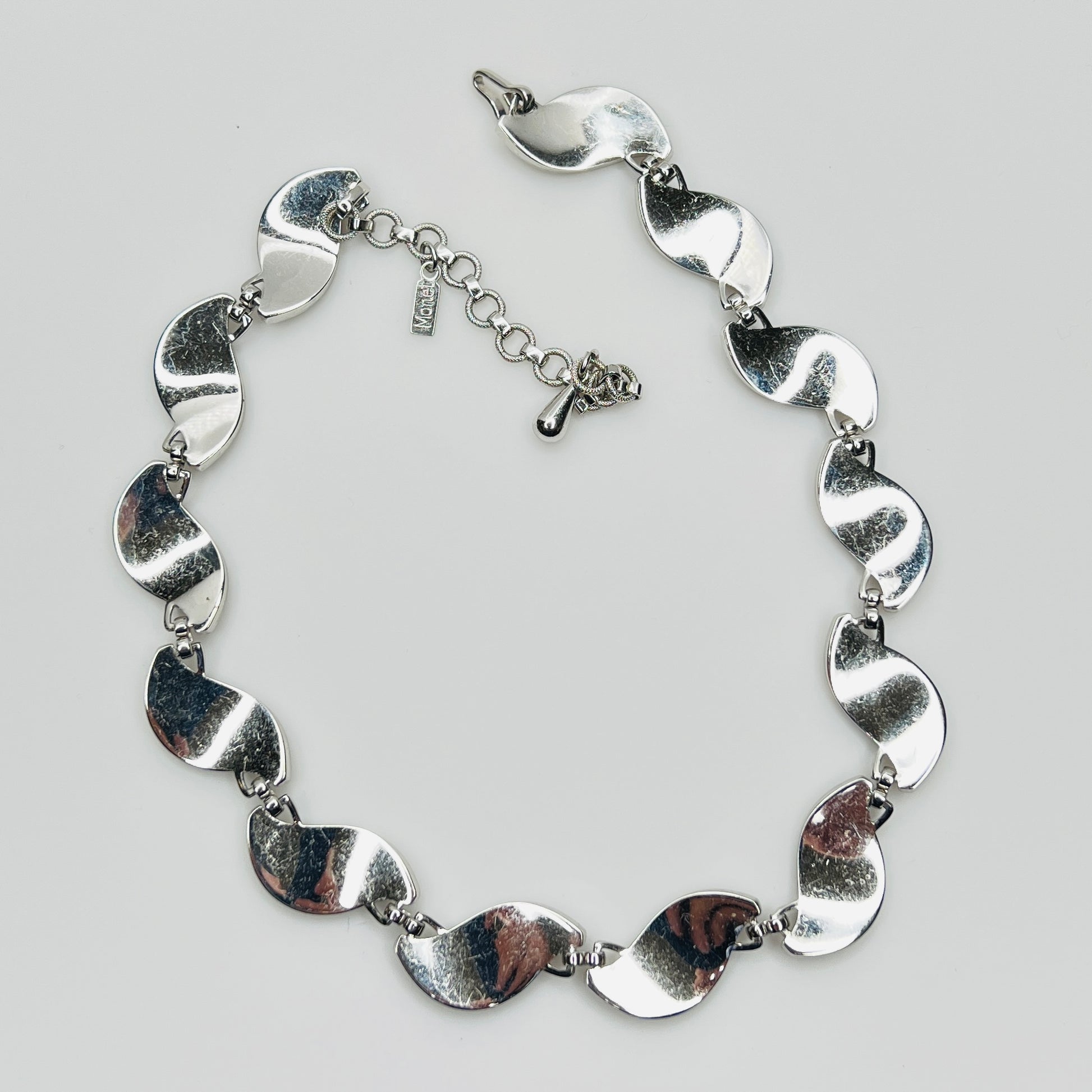 back view Close-up of silver Monet choker with curved leaf links