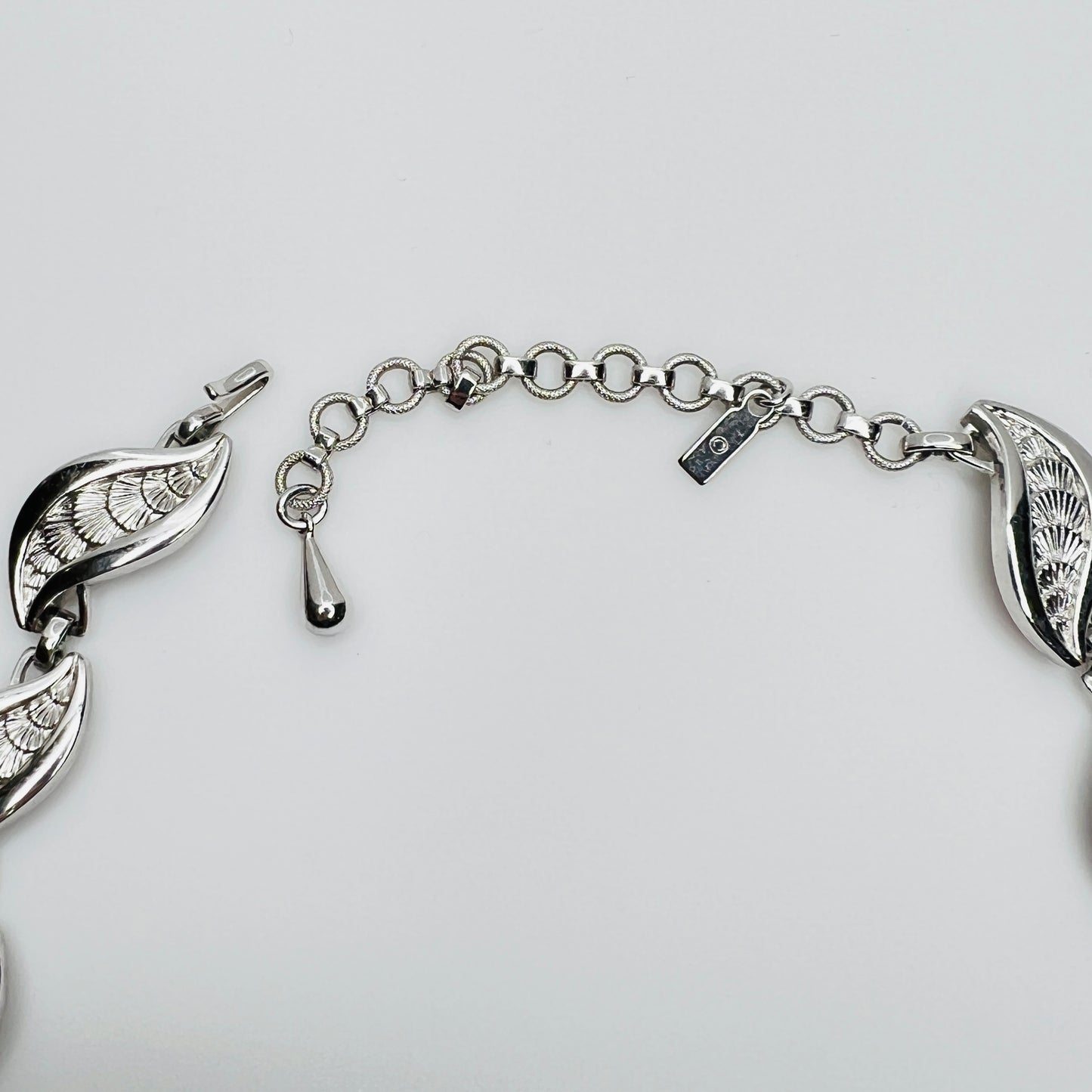 Close-up of silver Monet choker extender with curved leaf links