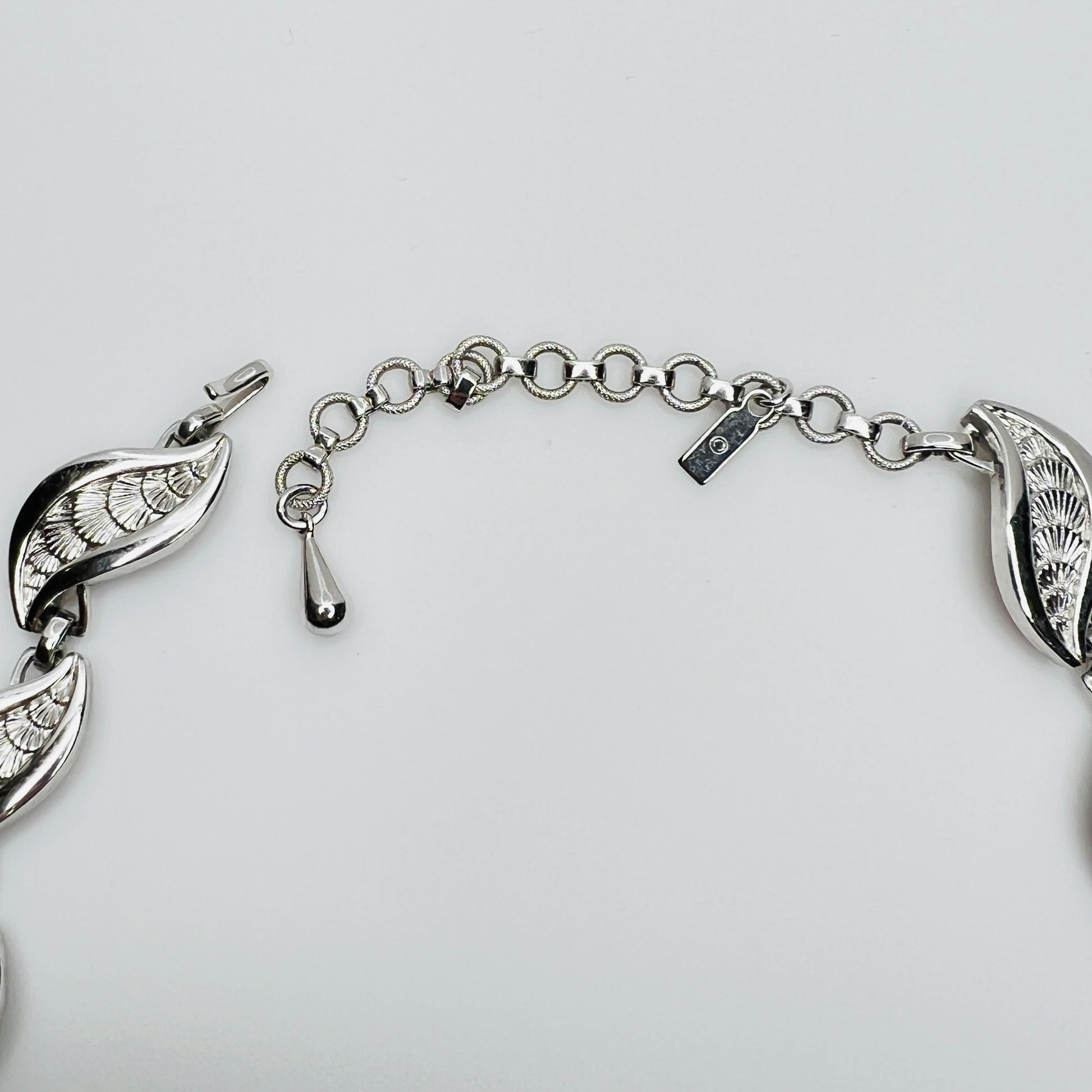 Close-up of silver Monet choker extender with curved leaf links