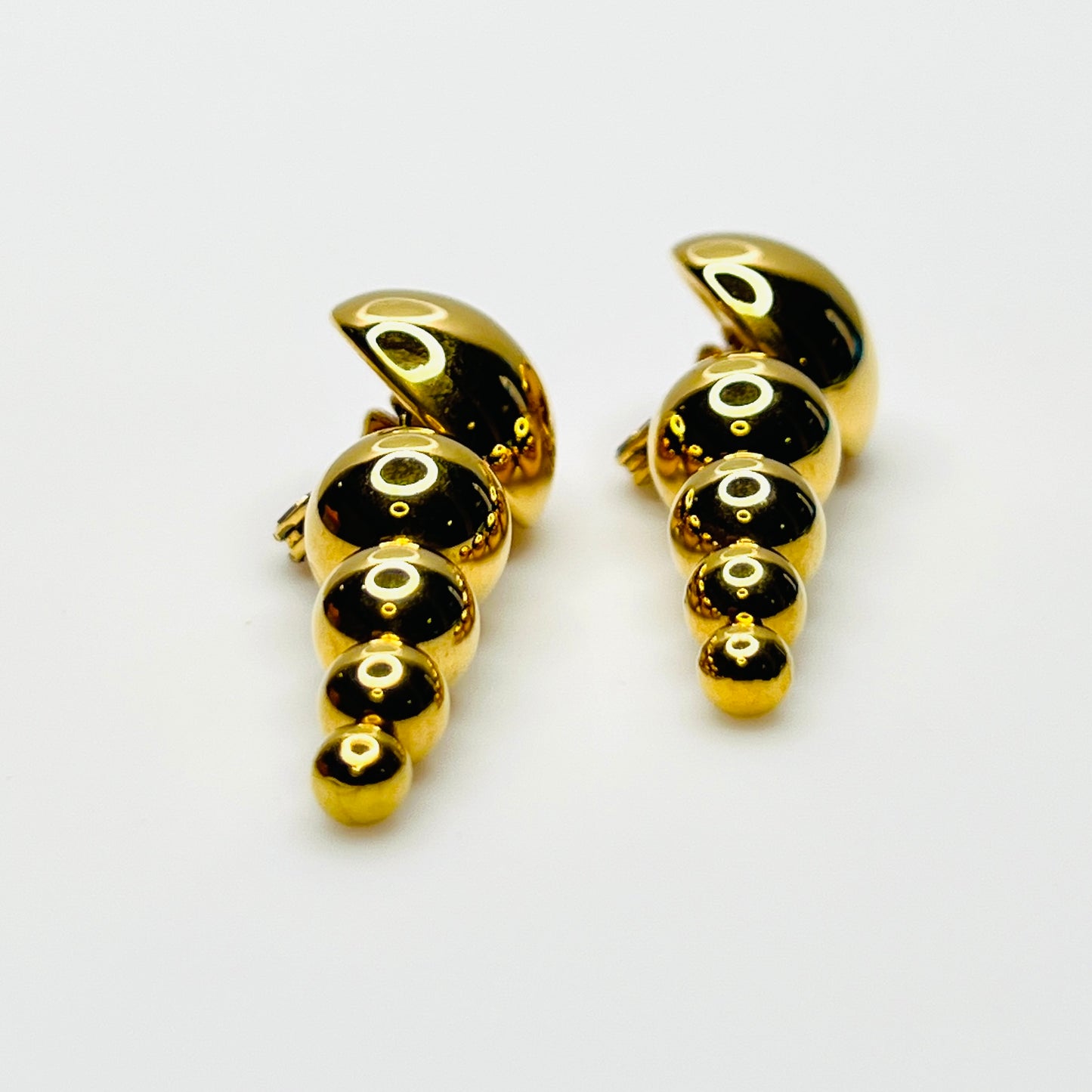 Side profile of vintage Monet gold-tone graduated bead earrings