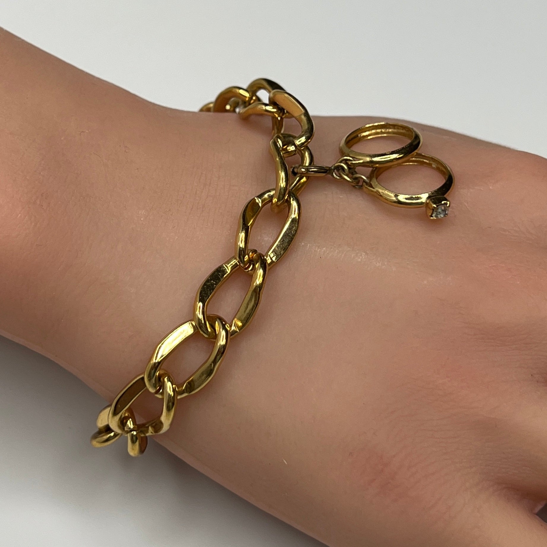 Gold-tone chain bracelet with rhinestone wedding ring charm by Monet