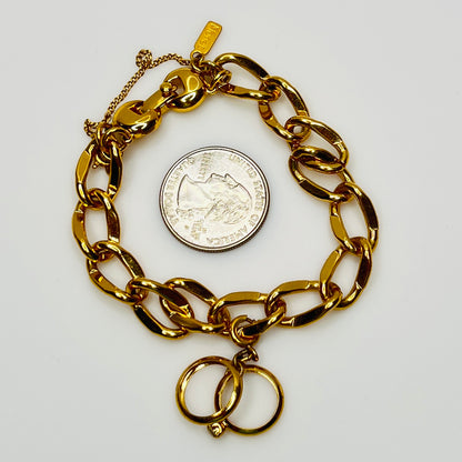 Gold-tone chain bracelet with rhinestone wedding ring charm by Monet