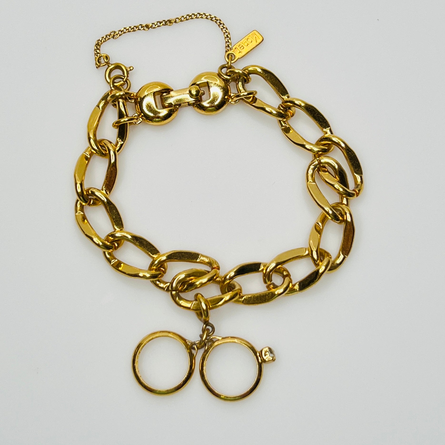 Gold-tone chain bracelet with rhinestone wedding ring charm by Monet